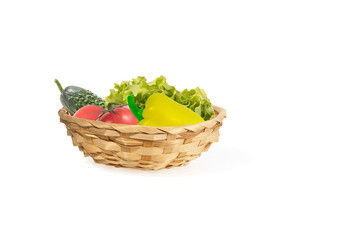 fresh vegetables in wicker basket isolated on white background