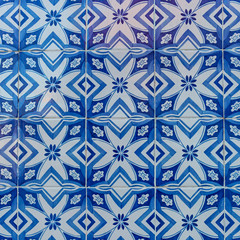 a fragment of the outer wall of a house in Lisbon decorated with ceramic tiles with a beautiful geometric pattern