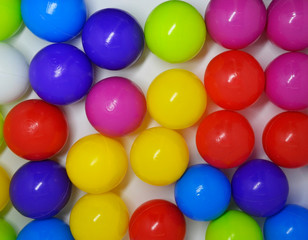 Fototapeta na wymiar multi-colored plastic balls on a white background. toys for a dry pool for children