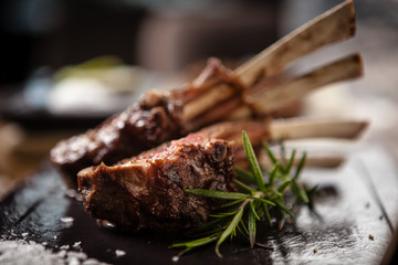 Grilled lamb chops served with a branch of rosemary - 329049212