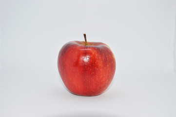  red, ripe, juicy apple on a white background. apple is a source of iron, vitamins and minerals