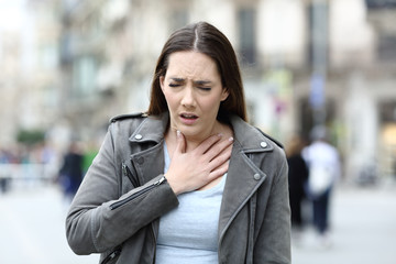 Woman suffering lack of breath on street