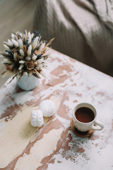 Coffee cup with flowers. Stylish flat lay. Home decoration. Cozy warm image, hygge style