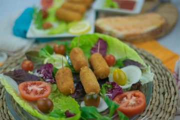 homemade chicken croquettes with tomato and lettuce