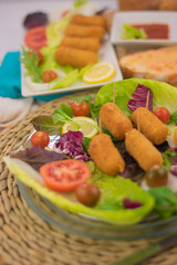 Homemade croquettes with tomato and lettuce