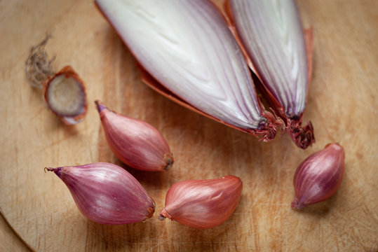 Red Spring Onions On A Wooden Board 