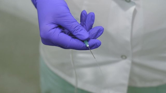 doctor checks an intravenous infusion needle