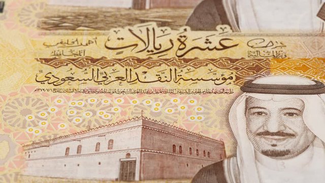 Saudi Arabia 10 riyal notes tracking. Saudi Arabian currency close up. Slider shot. Low angle, macro. 4K