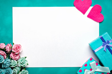 Greeting card with flowers and heart. Background with copy space. Selective focus. Top view.