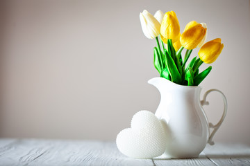 Greeting card with flowers and heart. Background with copy space. Selective focus.