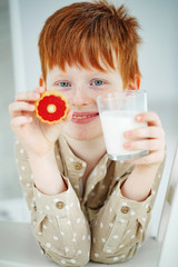 A child drinks milk with cookies.