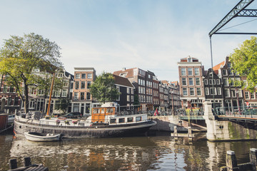 Beautiful street and canal in Amsterdam old town, Netherlands. Popular travel destination and tourist attraction