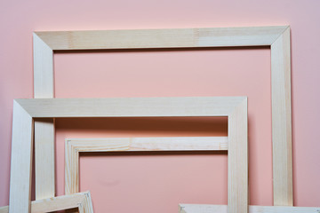 Wooden frames on a pink background. Abstraction. Frames for photos and paintings. Decoration