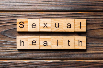 Sexual health word written on wood block. Sexual health text on table, concept