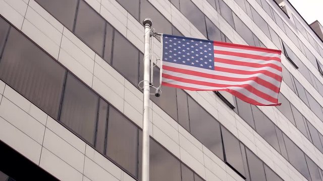 USA flag on the background of offices.USA flag on the background of an office building.