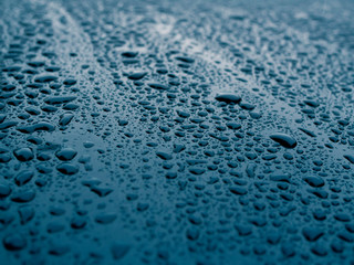 Obraz premium Blue wet, smooth surface of painted metal