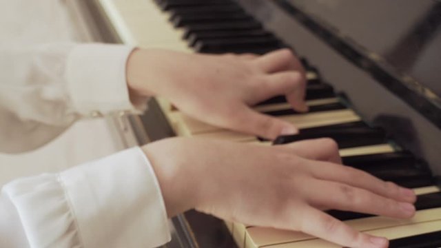 Closeup Of A Young Girl Hands Playing Old Piano