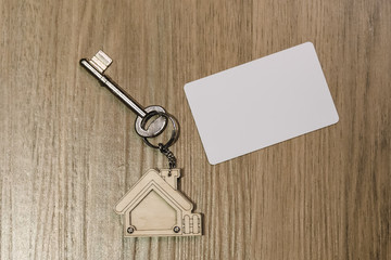house key with mockup of credit card on wood table