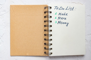 To do list - make more monTo do list - make more money written text on note pad. Close upe written...