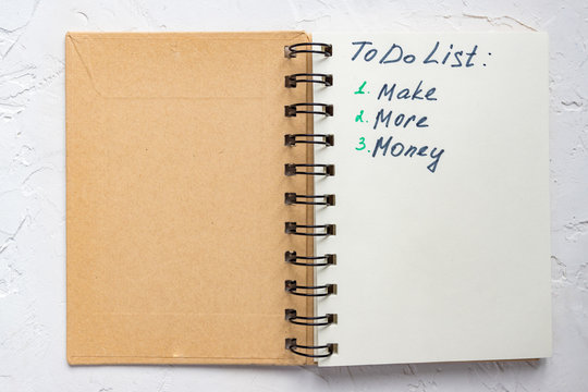 To do list - make more monTo do list - make more money written text on note pad. Close upe written text on note pad.