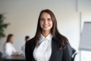 Close up portrait happy confident businesswoman looking at camera. Smiling female manager, team leader, consultant, successful coach speaker mentor, young company owner, specialist employee head shot.