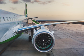 Airplane being preparing ready for takeoff and flight in international airport at sunset - Travel...