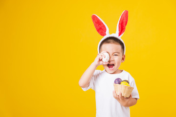 little children boy smile standing so happy bunny ears in Easter festival day holding easter eggs