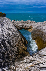 Aerial landscape of Cobijero beach and the natural arch El Salto del Caballo, Buelna, Llanes council, Asturias, Cantabrian Sea, Spain, Europe