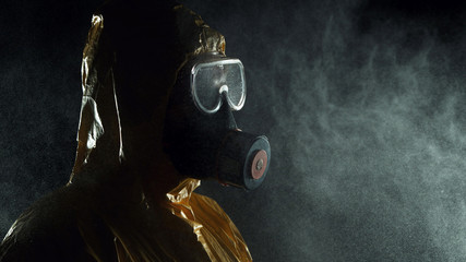 Man in chemical suit with respirator and goggles.