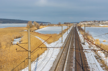 Railroad winter landscape with place where small river Karachokrak flows into Dnipro, Ukraine