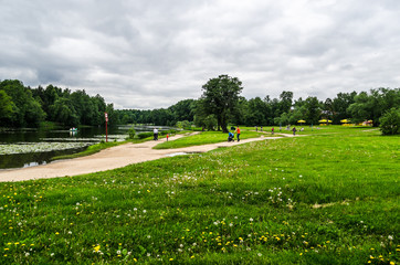 City landscape park with lawns, a lake and hiking trails, Moscow, Kuzminki Park, Russia, August 11,...
