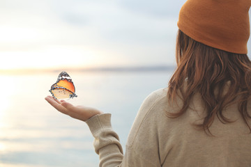 delicate moment  between a butterfly and a woman