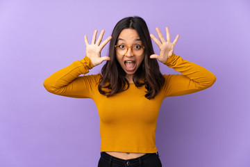 Young mixed race woman isolated on purple background counting ten with fingers