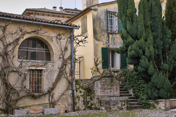 Fototapeta na wymiar Old two-story villa with a dried tree