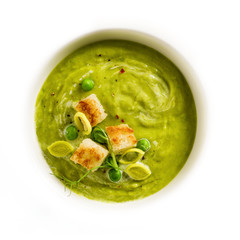 Pea puree soup with croutons. View from above. Close-up. Vegetarian cream soup