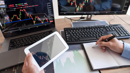 Businessman broker Analyzing finance data graphs and reports on screen for investment purposes for trading graph of stock market.