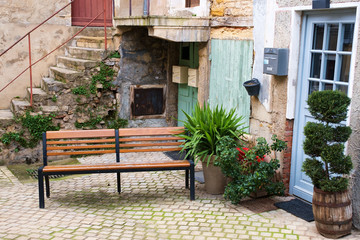 Fototapeta na wymiar bench in front of old house. France, Trevoux.