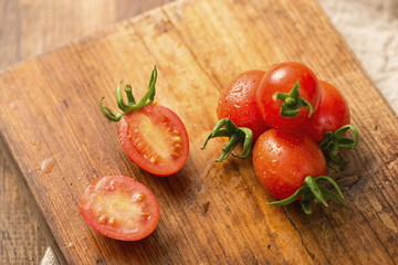 The cherry tomato is a type of small round tomato believed to be an intermediate genetic admixture between wild currant-type tomatoes and domesticated garden tomatoes. with white background.