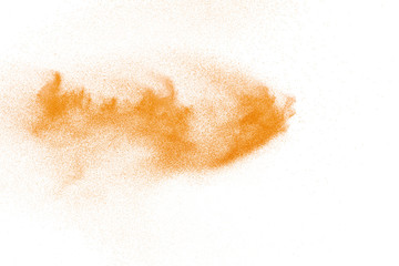 Orange powder dust particles explosion on white  background.Orange dust particles splash.