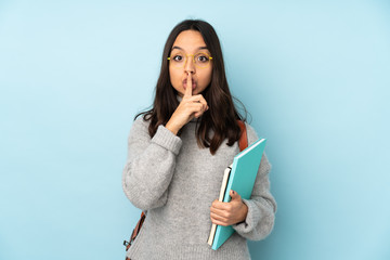 Young mixed race woman going to school isolated on blue background showing a sign of silence...
