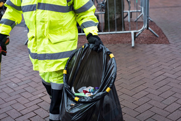 A image of Bin man picking up rubbish in Carlisle Cumbria.