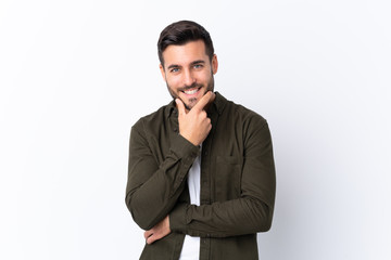 Young handsome man with beard over isolated white background smiling