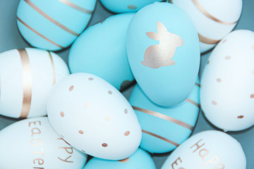 Easter background with Easter eggs in bird nest on blue background