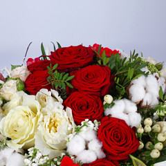 Flower arrangement with roses on neutral grey background