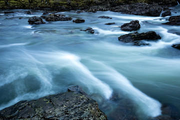 Long exposure shot of the waterfalls in Glen Orchy near Bridge of Orchy in the Argyll region of the highlands of Scotland during winter whilst the river is flowing fast from rainfall