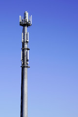 tower for mobile operator phone relay antenna on blue background sky
