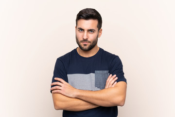 Fototapeta premium Young handsome man with beard over isolated background feeling upset