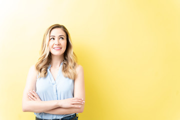 Pretty Thoughtful Woman Standing With Arms Crossed