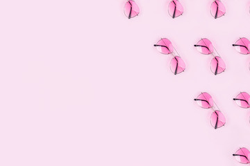 Pink stylish glasses on a pink background