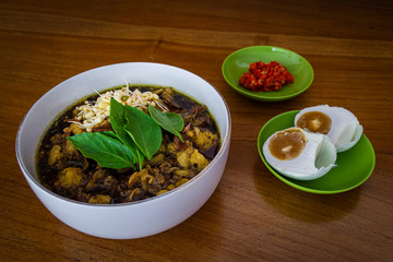 Rawon or beef black soup is one of Indonesian traditional food. made from beef, keluak (pangium edule), bean sprouts and various kinds of seasonings. rawon served with salted duck egg and chili